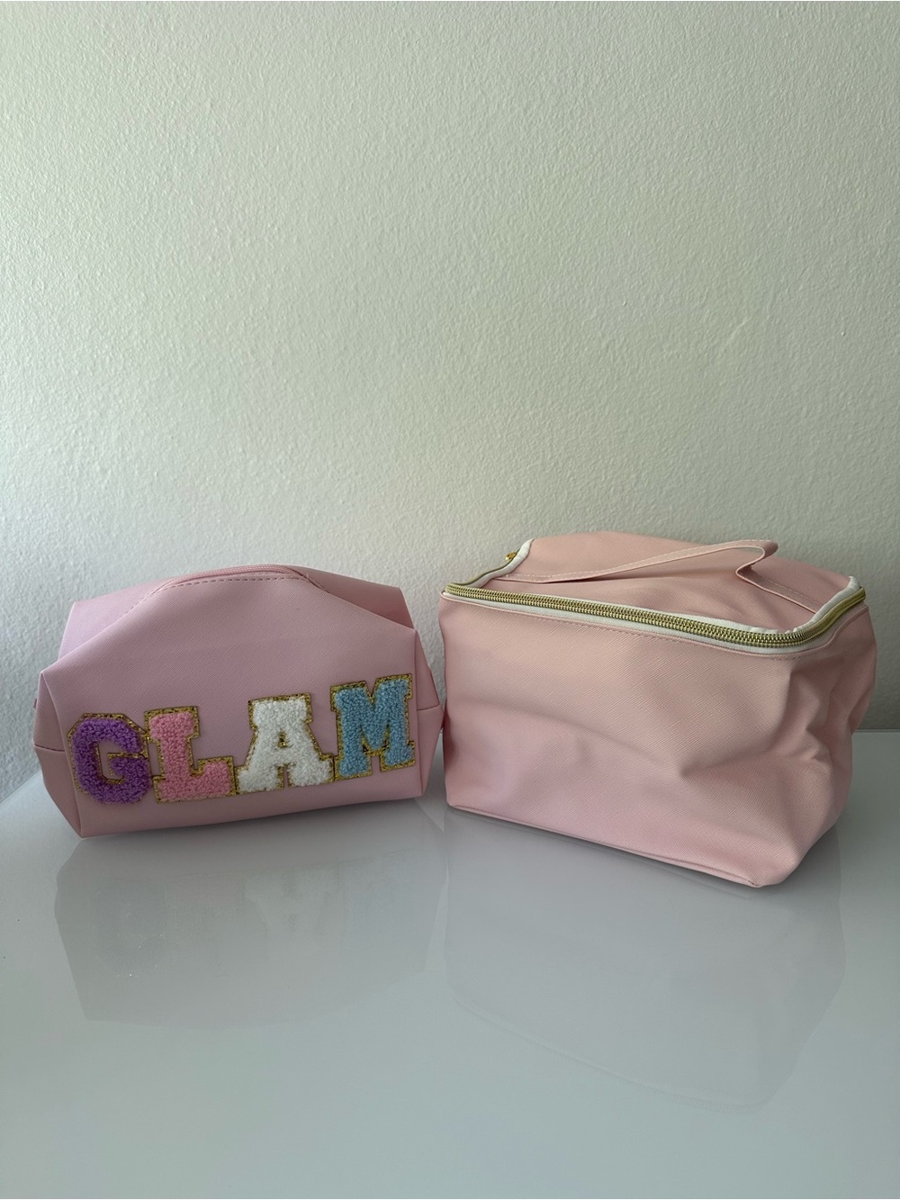 Sassy + Chic large zippered makeup bag and Glam makeup bag, both pastel pink.